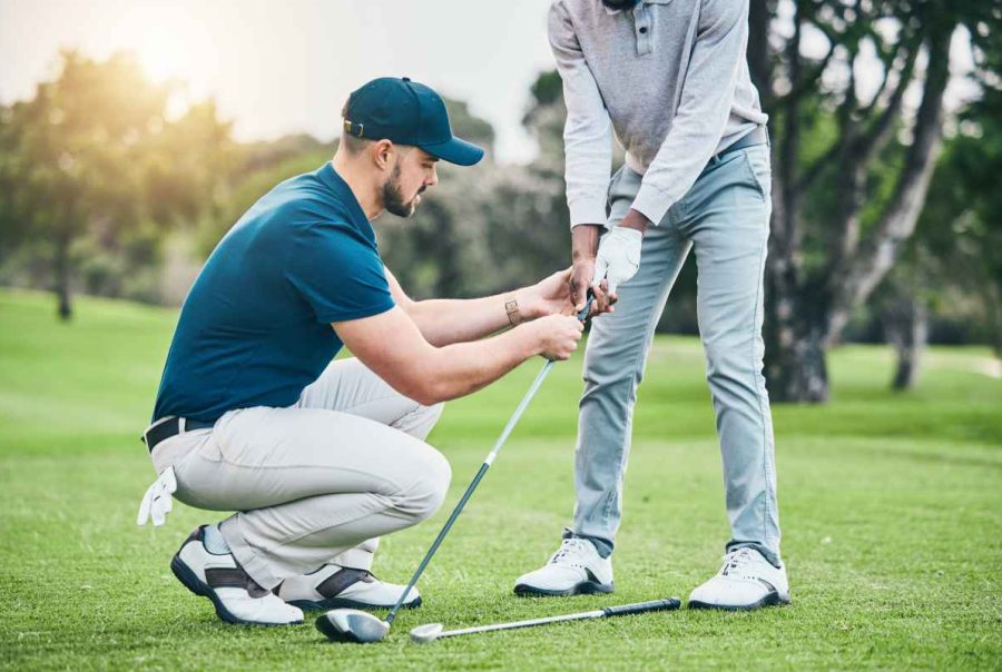 up close of man helping golfer with this stance