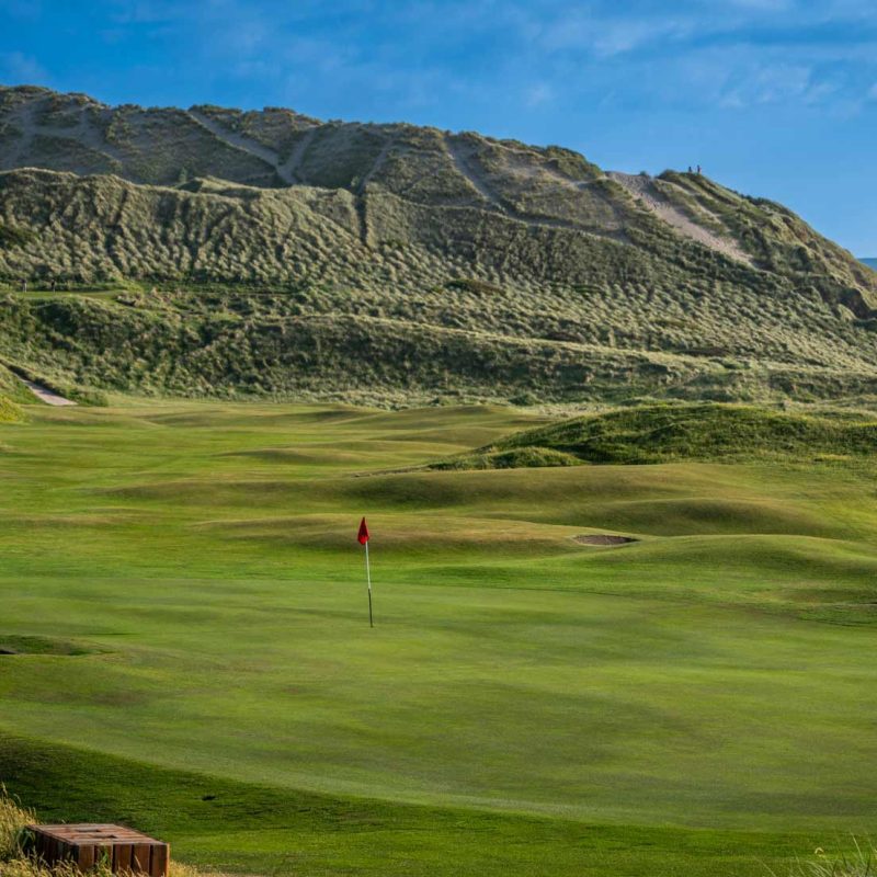 Rolling dunes in the background above the golf course