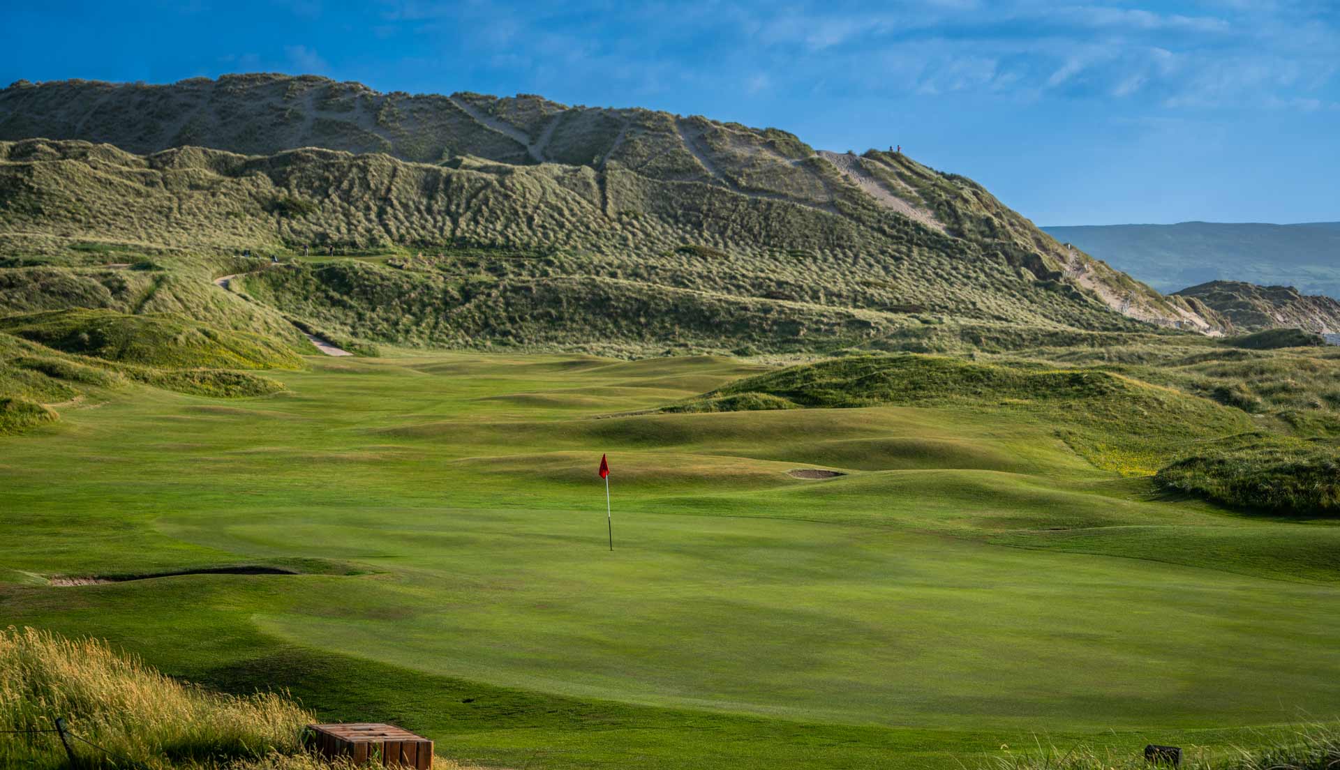 Rolling dunes in the background above the golf course